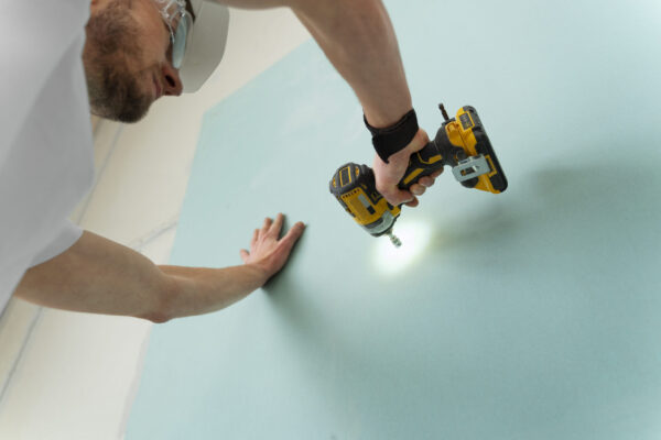 man-working-with-drill-low-angle